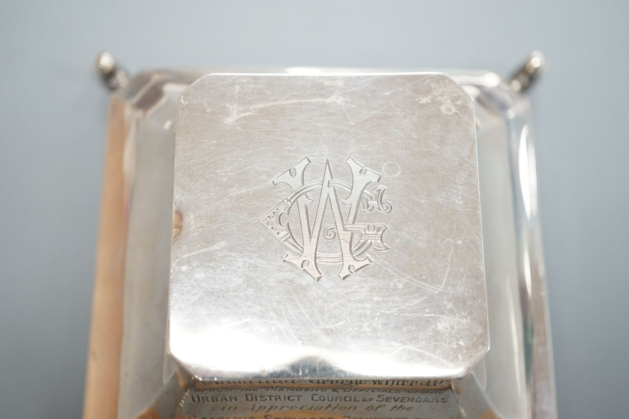A George V silver mounted inkwell, Birmingham, 1924, with presentation inscription and monogram, 14.2cm.